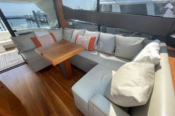 Slide: The Image of Luxurious interior of 2016 Sunseeker Predator 57 yacht with plush seating and wooden table. - 17