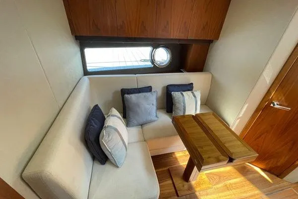 Slide: The Image of Luxurious interior of 2016 Sunseeker Predator 57 yacht with cozy seating and wooden table. - 37