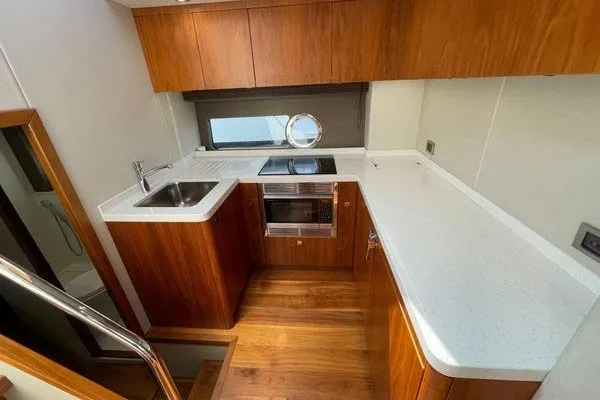 Slide: The Image of Modern kitchen interior of 2016 Sunseeker Predator 57 yacht with wood cabinetry. - 43