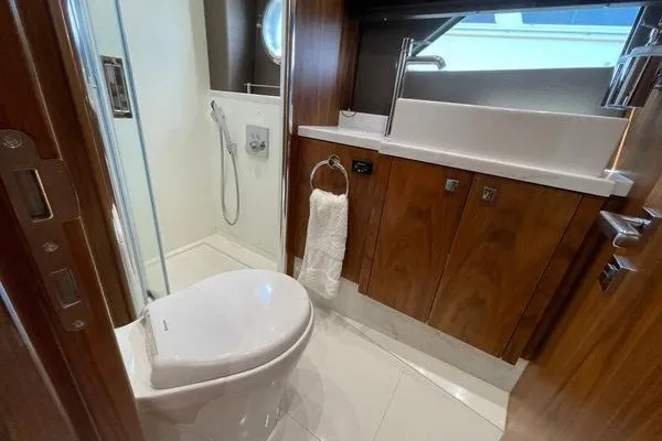 Slide: The Image of Luxurious bathroom in 2016 Sunseeker Predator 57 yacht with modern fixtures and wood cabinetry. - 59