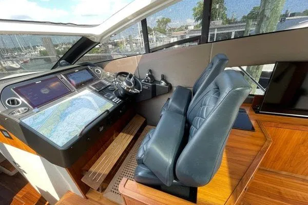 Slide: The Image of 2016 Sunseeker Predator 57 yacht helm with dual leather seats and navigation screens. - 21