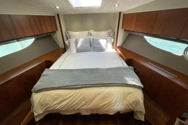 Slide: The Image of Luxurious cabin interior of 2016 Sunseeker Predator 57 yacht with cozy bed and wooden accents. - 32