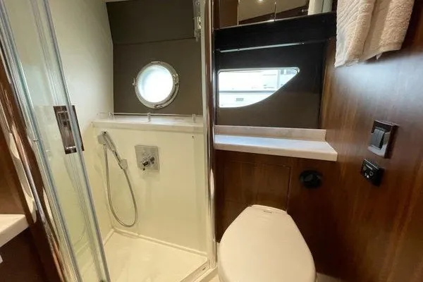 Slide: The Image of Luxurious bathroom in 2016 Sunseeker Predator 57 yacht with shower and porthole. - 35