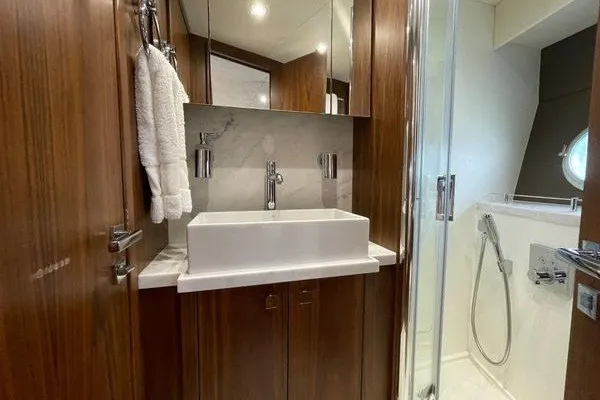 Slide: The Image of Luxurious bathroom in 2016 Sunseeker Predator 57 yacht with modern fixtures and wood accents. - 34