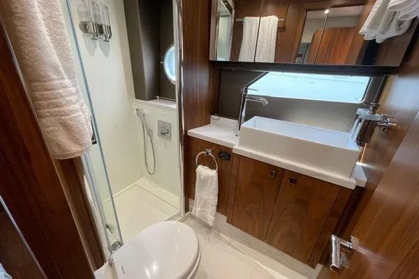 Slide: The Image of Luxurious bathroom in 2016 Sunseeker Predator 57 yacht with modern fixtures and wood accents. - 57