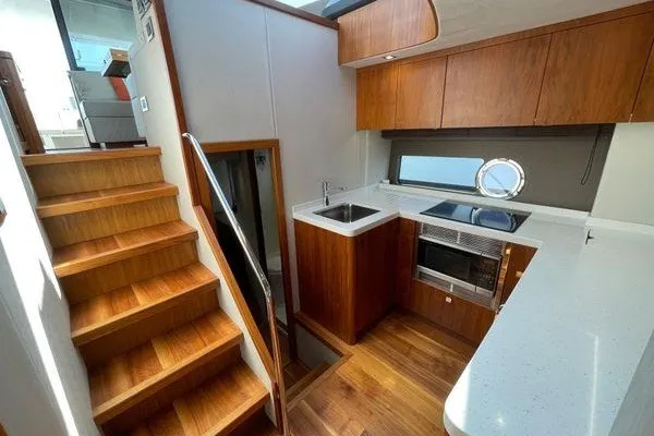 Slide: The Image of Luxurious interior of 2016 Sunseeker Predator 57 yacht with modern kitchen and wooden stairs. - 40