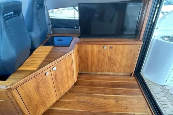 Slide: The Image of Luxurious interior of 2016 Sunseeker Predator 57 yacht with wood cabinetry and seating. - 19