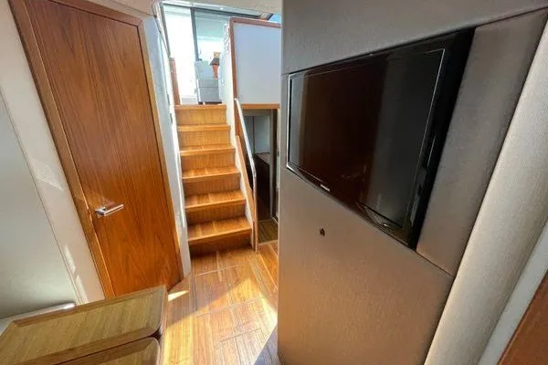 Slide: The Image of Interior of 2016 Sunseeker Predator 57 yacht with wooden stairs and wall-mounted TV. - 38