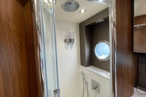 Slide: The Image of Luxurious bathroom in 2016 Sunseeker Predator 57 yacht with shower and porthole window. - 58