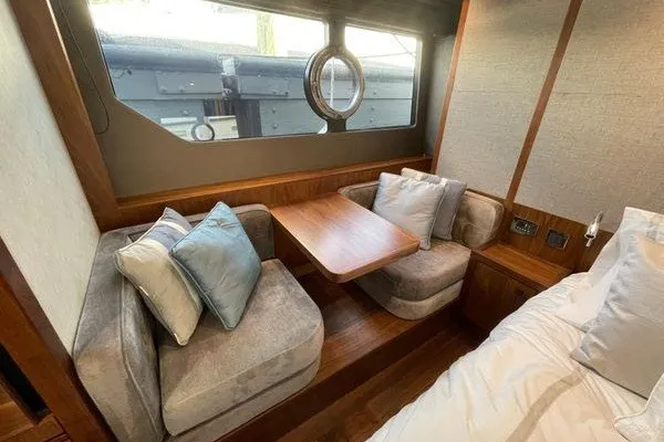 Slide: The Image of Luxurious interior of 2016 Sunseeker Predator 57 yacht with cozy seating and table. - 56