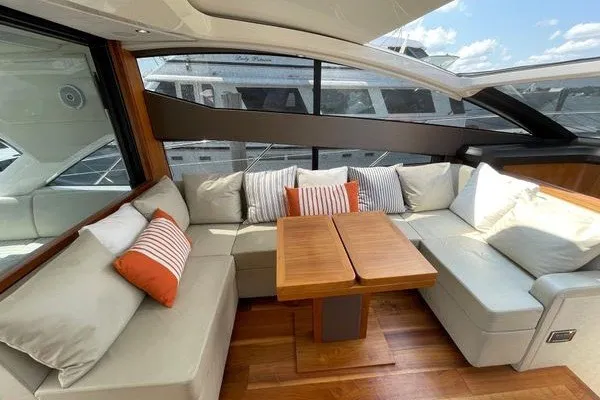 Slide: The Image of Luxurious interior of 2016 Sunseeker Predator 57 yacht with plush seating and wooden table. - 16