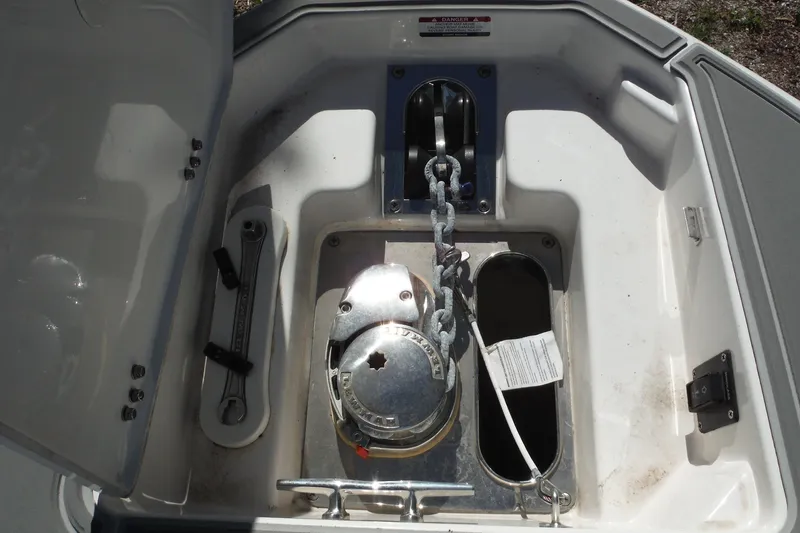 Slide: The Image of Anchor compartment of 2025 Chaparral 310 OSX boat with chain and tools. - 41