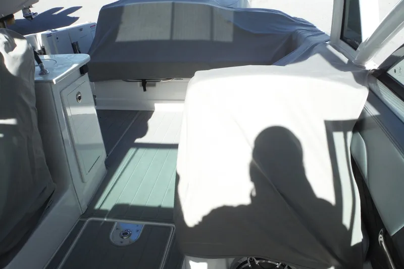 Slide: The Image of Interior of 2025 Chaparral 310 OSX boat with covered seating and shadow. - 57