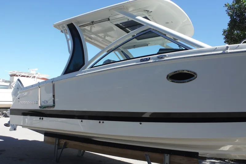 Slide: The Image of 2025 Chaparral 310 OSX boat with sleek design and modern features. - 22