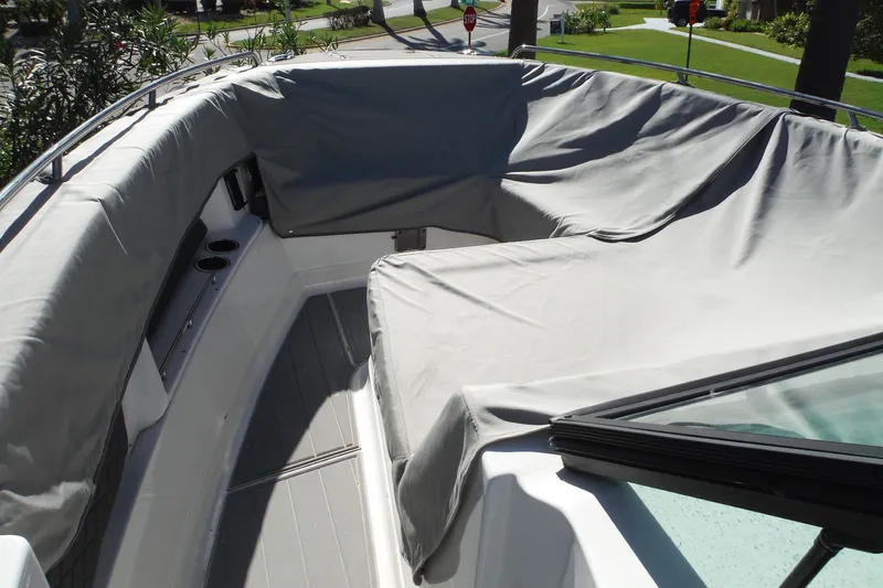 Slide: The Image of 2025 Chaparral 310 OSX boat with covered seating area and sleek design. - 53