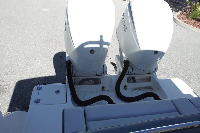 Slide: The Image of 2025 Chaparral 310 OSX boat with dual outboard engines, rear view. - 35