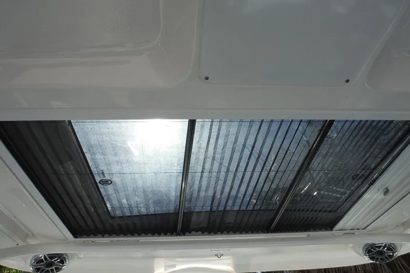 Slide: The Image of 2025 Chaparral 310 OSX boat roof with transparent panels and integrated speakers. - 49