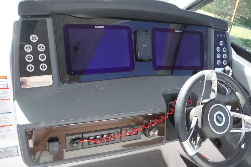 Slide: The Image of 2025 Chaparral 310 OSX dashboard with dual Simrad displays and modern steering wheel. - 33