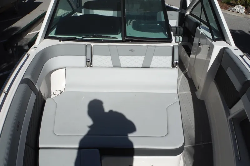 Slide: The Image of 2025 Chaparral 310 OSX boat interior with cushioned seating and modern design. - 42