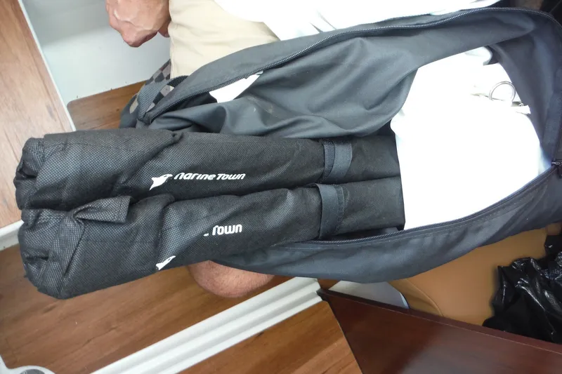 Slide: The Image of Bag with folded black covers labeled "Marine Town" on Chaparral 310 OSX, 2025 model. - 60