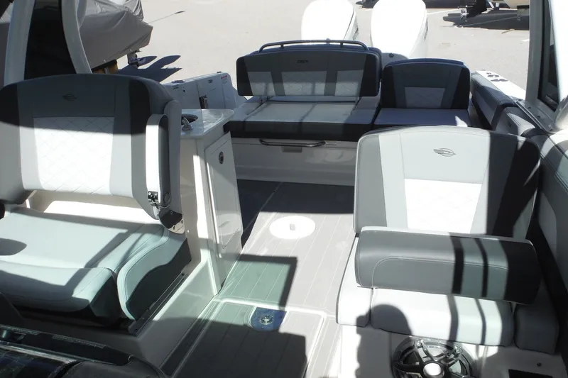 Slide: The Image of 2025 Chaparral 310 OSX boat interior with modern seating and sleek design. - 31