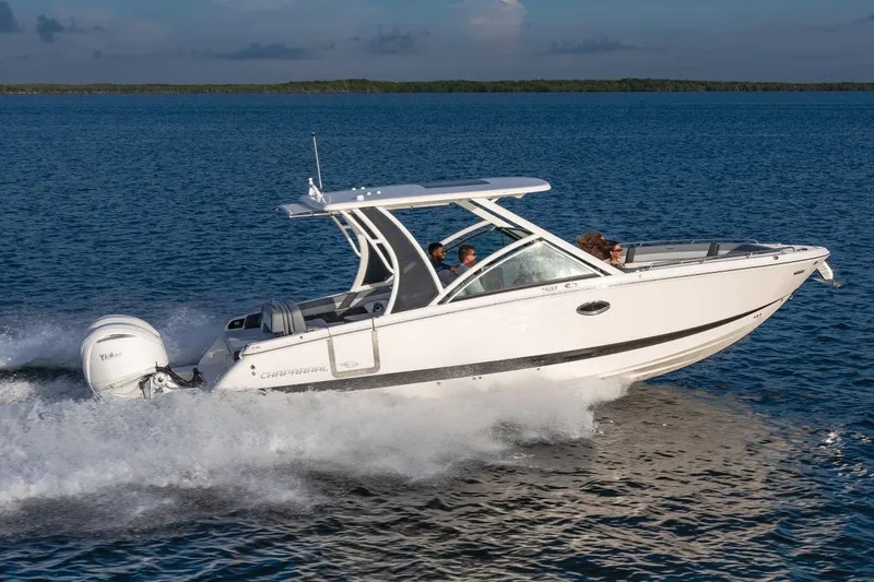 Slide: The Image of Manufacturer Provided Image: 2025 Chaparral 310 OSX boat cruising on open water, side view. - 1