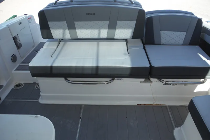 Slide: The Image of 2025 Chaparral 310 OSX boat interior seating with gray and white upholstery. - 34