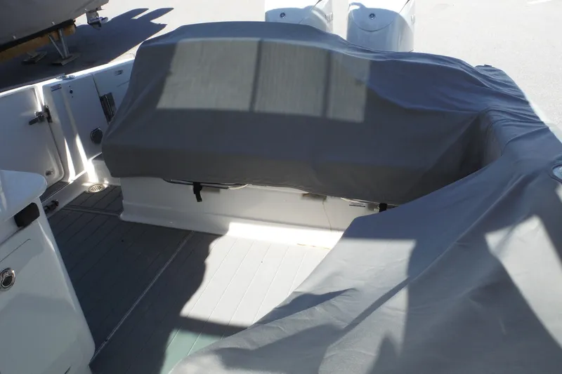 Slide: The Image of Covered seating area on a 2025 Chaparral 310 OSX boat deck. - 58