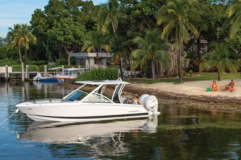 Slide: The Image of Manufacturer Provided Image: 2025 Chaparral 310 OSX boat near tropical beach with palm trees and people relaxing. - 3