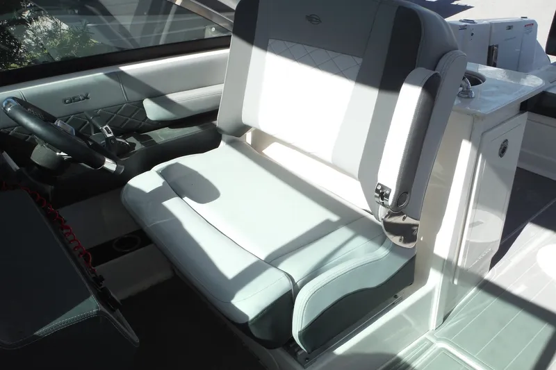 Slide: The Image of 2025 Chaparral 310 OSX boat interior with modern seating and steering wheel. - 32