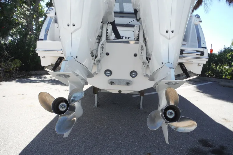 Slide: The Image of 2025 Chaparral 310 OSX boat with dual outboard motors and propellers. - 27