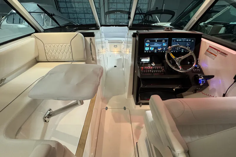 Slide: The Image of 2026 Pursuit DC 326 Dual Console interior with modern dashboard and comfortable seating. - 18