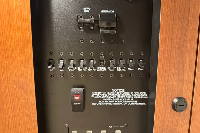 Slide: The Image of Electrical panel of 2026 Pursuit DC 326 Dual Console boat with switches and notice. - 26