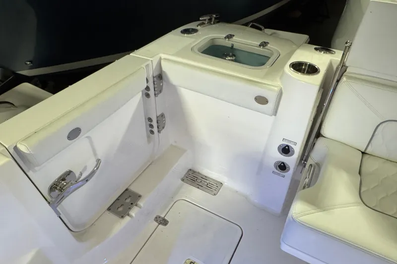 Slide: The Image of Interior of 2026 Pursuit DC 326 Dual Console boat, featuring seating and control panel. - 9