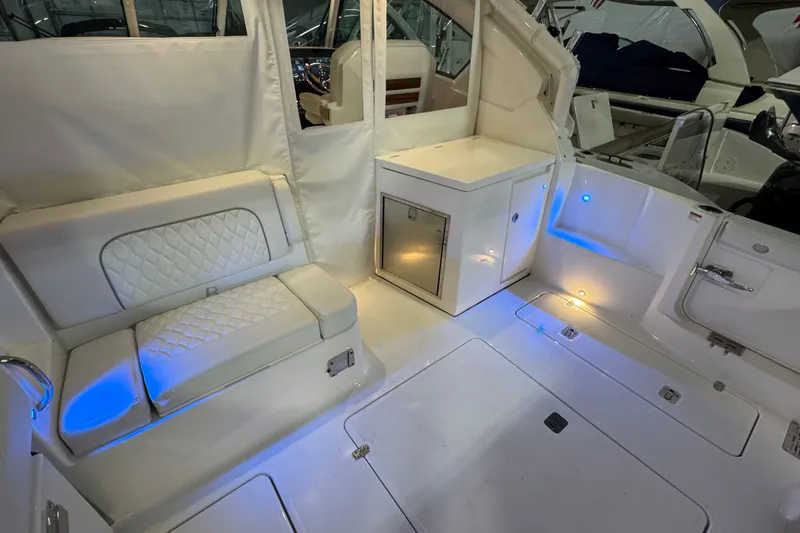 Slide: The Image of 2026 Pursuit DC 326 Dual Console interior with white seating and ambient lighting. - 14