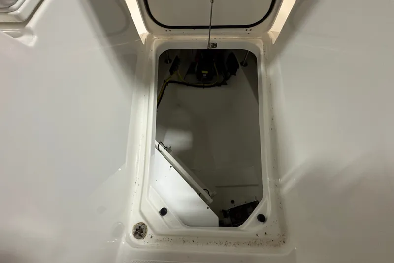 Slide: The Image of Open storage compartment on a 2026 Pursuit DC 326 Dual Console boat. - 33