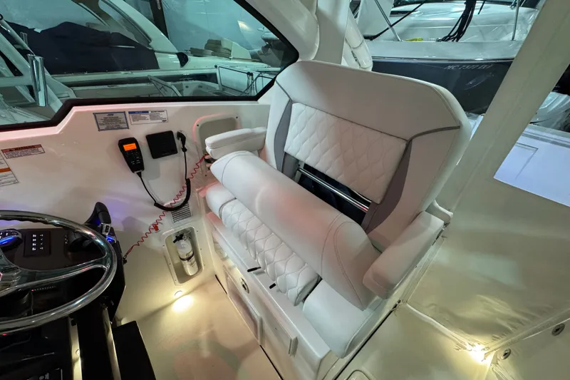 Slide: The Image of Interior of 2026 Pursuit DC 326 Dual Console boat with luxurious seating and controls. - 21