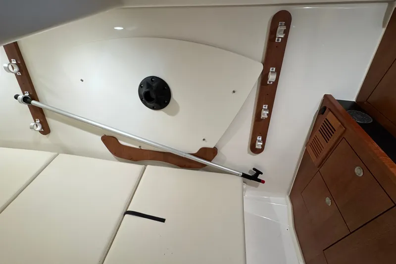 Slide: The Image of Interior of 2026 Pursuit DC 326 Dual Console boat with storage and seating. - 28