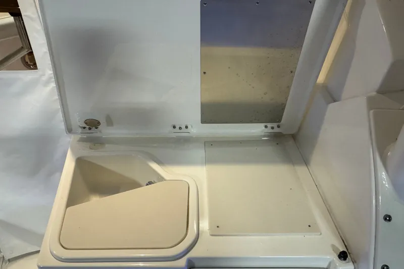 Slide: The Image of Interior view of 2026 Pursuit DC 326 Dual Console boat's storage compartment. - 11