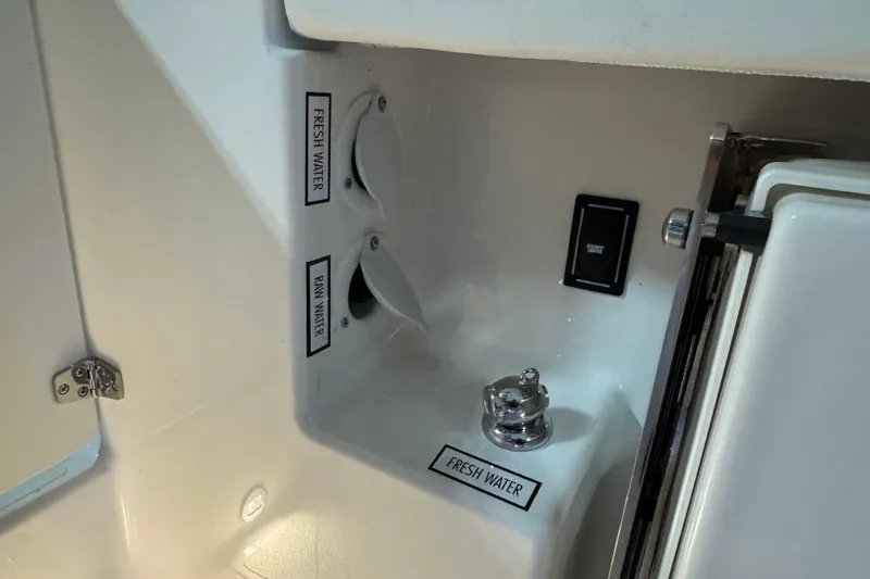 Slide: The Image of Fresh and raw water controls on 2026 Pursuit DC 326 Dual Console boat. - 13