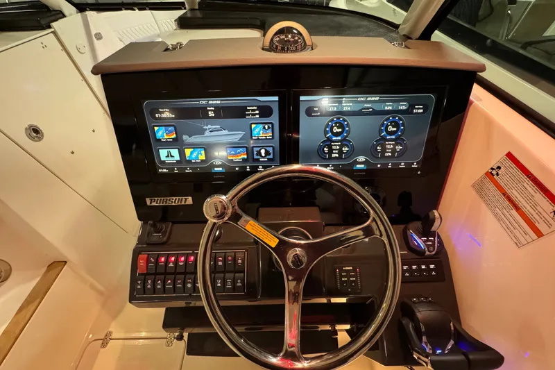 Slide: The Image of 2026 Pursuit DC 326 Dual Console dashboard with modern touchscreen displays and controls. - 23