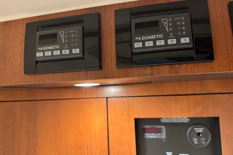 Slide: The Image of Dometic control panels on 2026 Pursuit DC 326 Dual Console boat interior. - 29