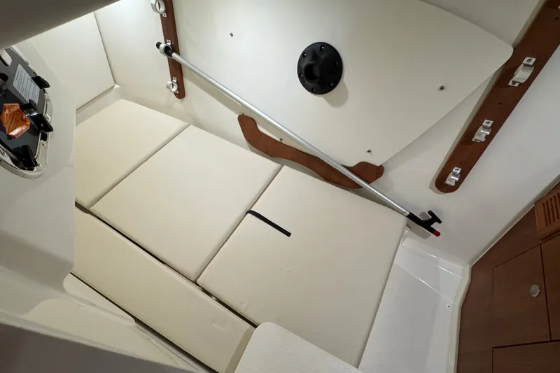 Slide: The Image of Interior cabin of 2026 Pursuit DC 326 Dual Console boat, featuring cushioned seating. - 27