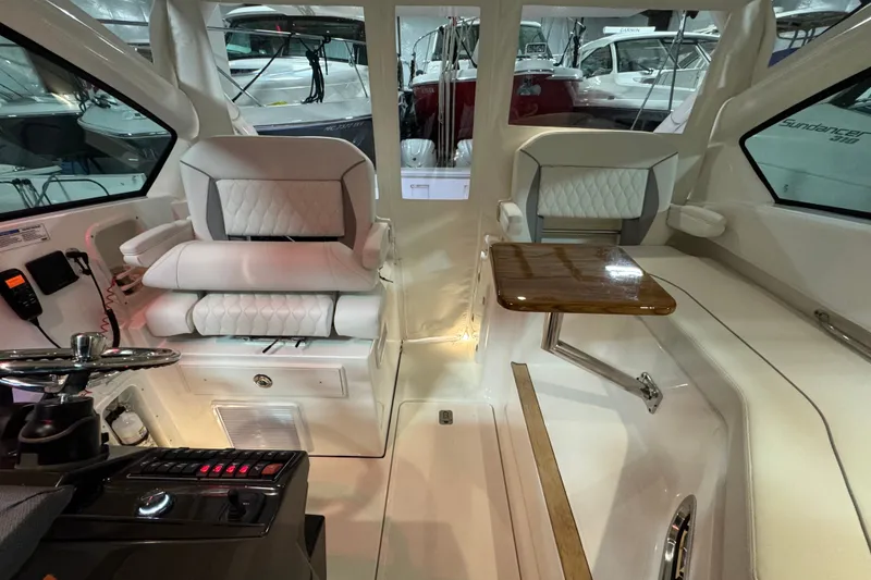 Slide: The Image of Interior of 2026 Pursuit DC 326 Dual Console, featuring plush seating and a wooden table. - 19