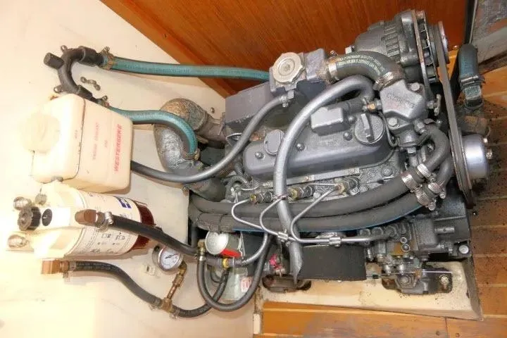 Slide: The Image of Catalina 310 2001 engine compartment with hoses and components visible. - 17