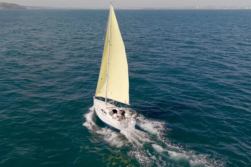 Slide: The Image of Sailboat Catalina 310 (2001) cruising on open sea with yellow sails. - 20