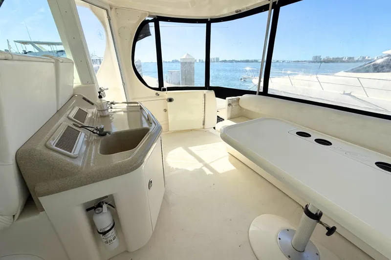 Slide: The Image of 2005 Sea Ray 390 Motor Yacht interior with sink, seating, and ocean view. - 11
