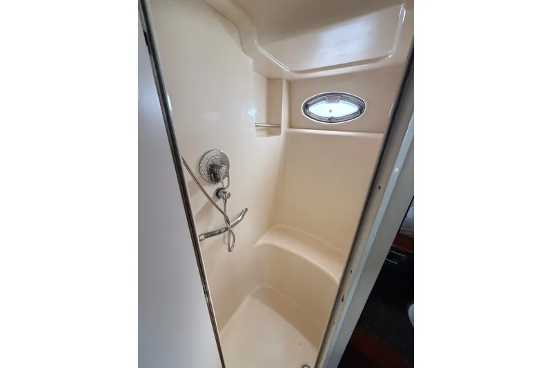 Slide: The Image of Shower area in 2005 Sea Ray 390 Motor Yacht with oval window and chrome fixtures. - 27
