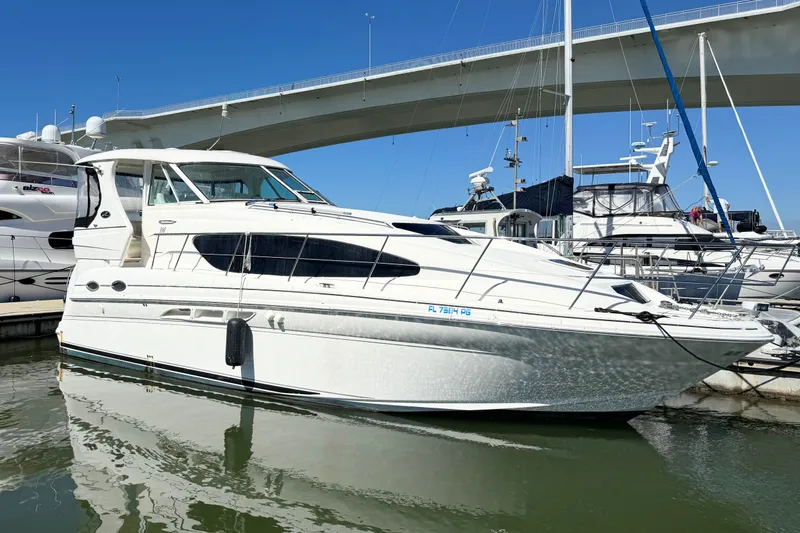 Slide: The Image of 2005 Sea Ray 390 Motor Yacht docked at marina under clear blue sky. - 4