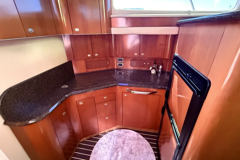 Slide: The Image of Luxurious 2005 Sea Ray 390 Motor Yacht kitchen with wood cabinetry and modern appliances. - 22